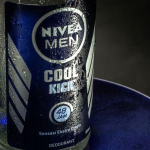 A refreshing close-up of Nivea Men Cool Kick deodorant with water droplets.